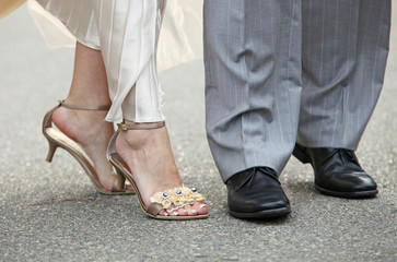 Close-up of feet of newly-married couple, outdoor shot
