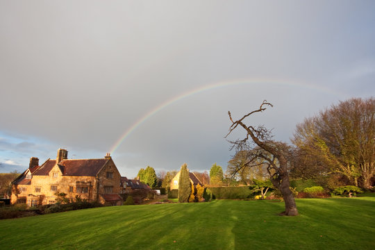 Rainbow over a manor house and garden