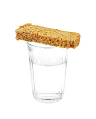 Glass of water and bread isolated on white background