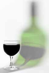 Red wine glass and bottle reflex