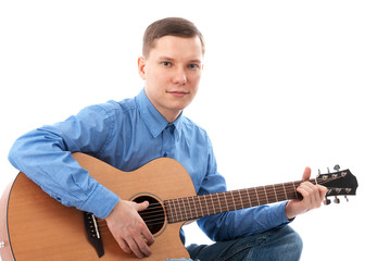 Obraz premium Young man playing an acoustic guitar