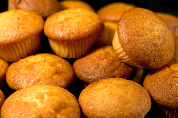 Many yellow cakes in cafe in morning