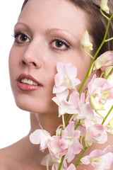 Pretty young woman portrait with orchid