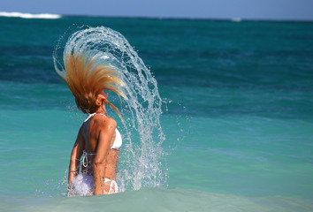 woman flips hair in turquoise waters