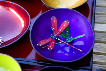 blue and red plates with art  dragonfly at flea market