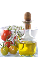 olive oil and branch of organic tomatoes