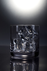 Front view of empty scotch glass on grey background