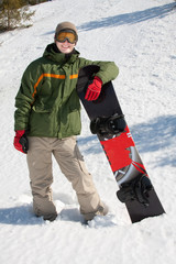 Happy young guy with snowboard