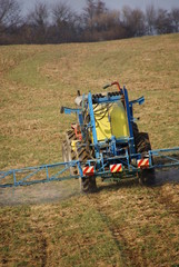 Farm machinery spraying field