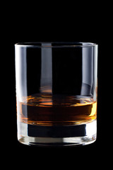 glass of whisky on black background.