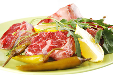 uncooked meat medallion on green