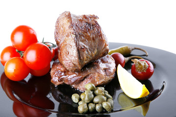 grilled meat medallion served on black