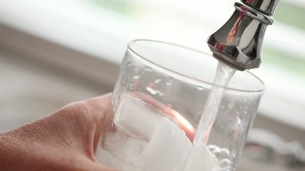 Female Getting Glass of Water from Sink Faucet