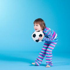 little girl playing with soccer ball