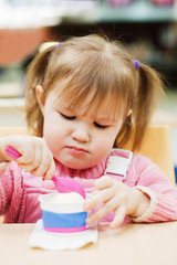 The little girl eats ice-cream