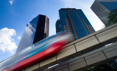 Modern monorail train with office buildings in the background © nrbk