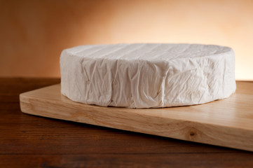 camembert on wood background