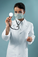 Pretty doctor examining with stethoscope