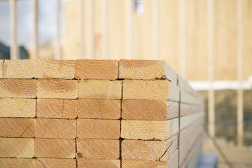 Close-up of Stacks of Lumber at a Construction Site - obrazy, fototapety, plakaty