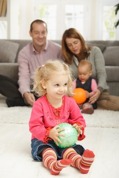 Smiling toddler with ball