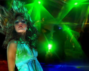 Beautiful young woman dancing in the nightclub.