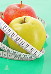 White tape measure around a red apple representing dieting