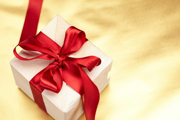 Beautiful gift box on the gold background