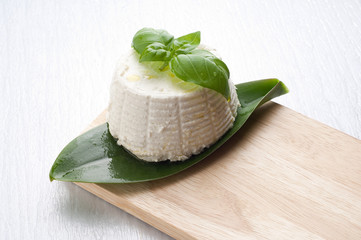 ricotta and basil on white glass background