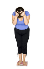 Woman standing on scales.