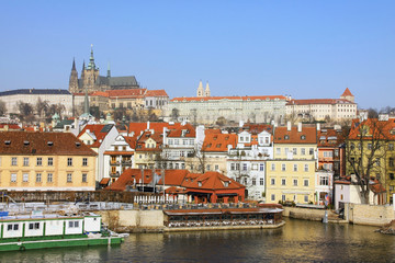 Fototapeta premium The snowy Prague gothic Castle above the River Vltava