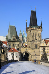 Obraz premium Snowy Prague St. Nicholas' Cathedral with Bridge Tower
