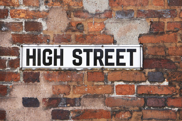 Fototapeta premium Rusty Metal High Street Road Sign On Brick Wall