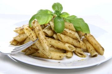 Italian cuisine - penne with pesto decorated with basil