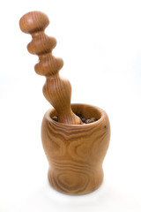 Wooden mortar and pestle for grinding dry food with allspice on