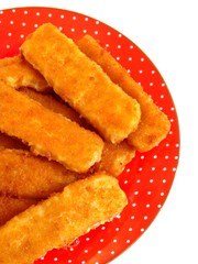 Fish fingers on the red plate. Isolation