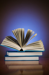 Stack of books against gradient background