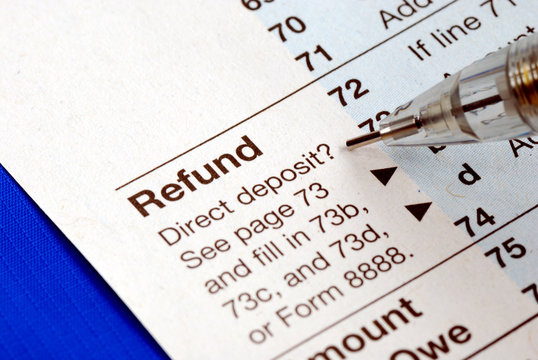 Getting Refund From The Income Tax Return Isolated On Blue