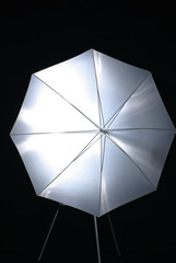 White photo umbrella on black background