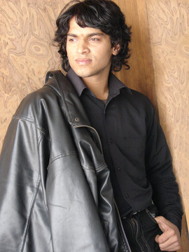 portrait of a young indian man wearing leather jocket