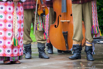 Women and men dressed in traditional clothes Lithuanian