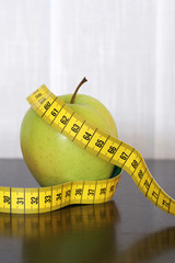 Measuring tape and apple
