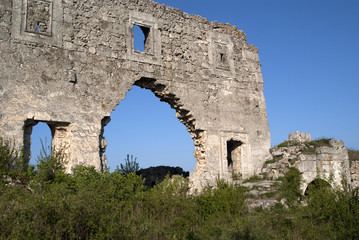 Fototapeta na wymiar wall of tumbledown monastery on a background dark blue sky