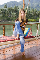 A girl sits on a swing