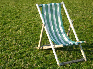 Green and white deckchair on grass