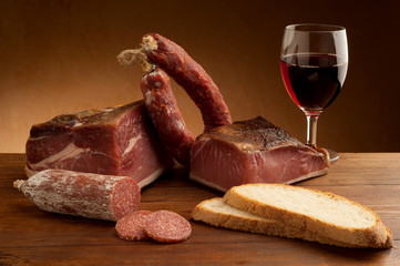 mix of parma prosciutto and salami with bread glass of wine