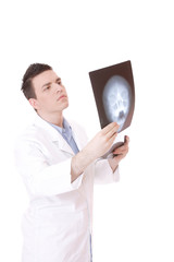 Caucasian mid adult male doctor holding up xrays.