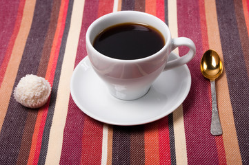 A coffee on a striped tablecloth