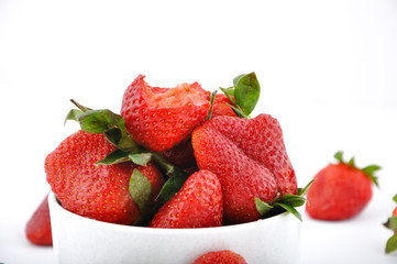 strawberries in bowl and one with bite