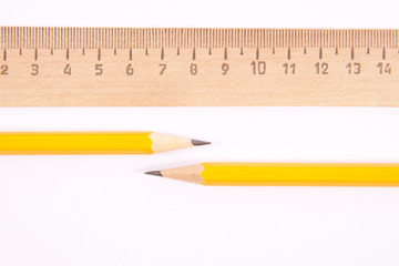 Ruler and two pencils isolated on white background