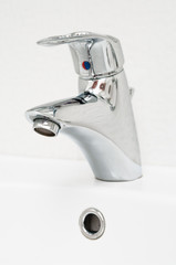One chrome faucet in washbowl in bath room on white pile